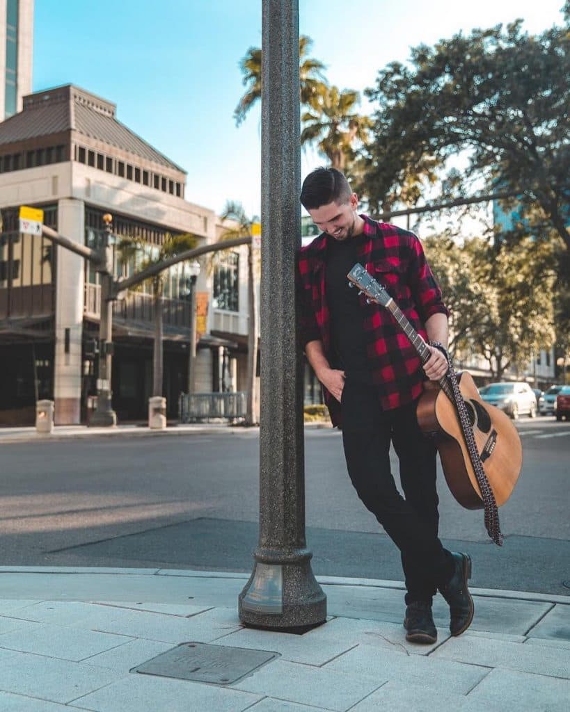 Guitarist on a Tampa sidewalk at golden hour