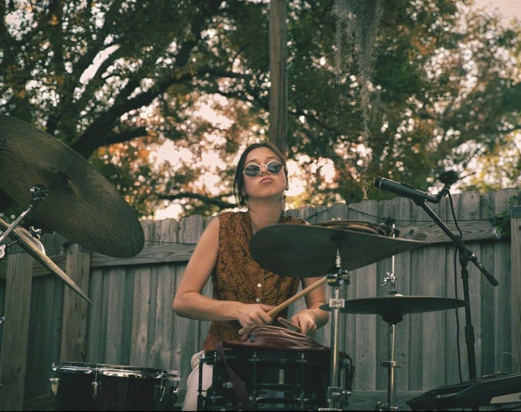 Drummer performing outdoors under live oak trees in Tampa