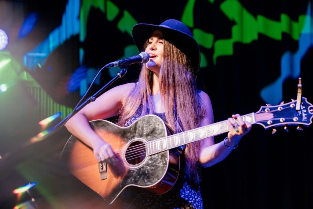 Live vocalist performing under stage lighting at a Tampa venue