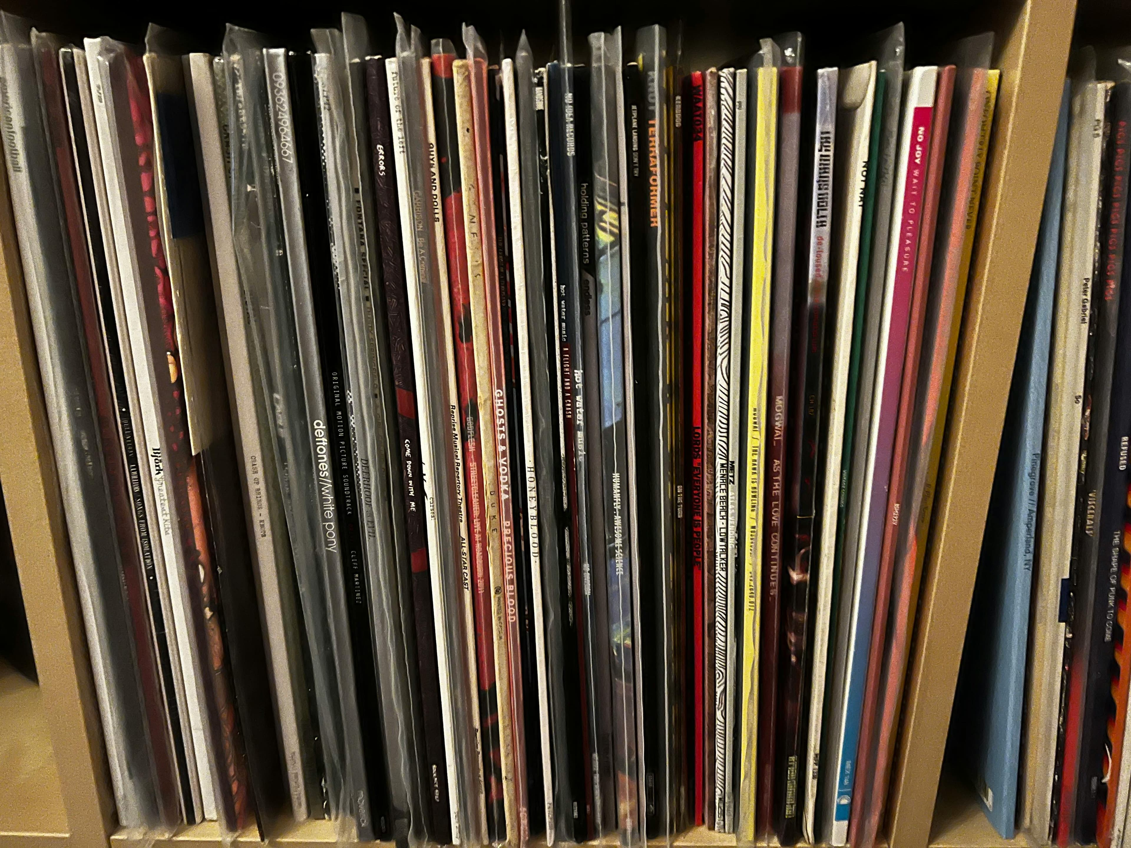 Wall of vinyl records in a DJ's crate, spines packed together and visible — the working library of an all-vinyl DJ